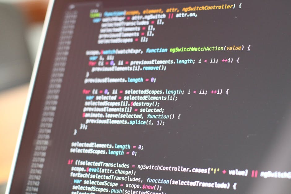 A close-up of a computer screen displaying a code editor with a dark background and multicolored syntax highlighting in shades of blue, green, pink, and white. The code appears to be written in a prog